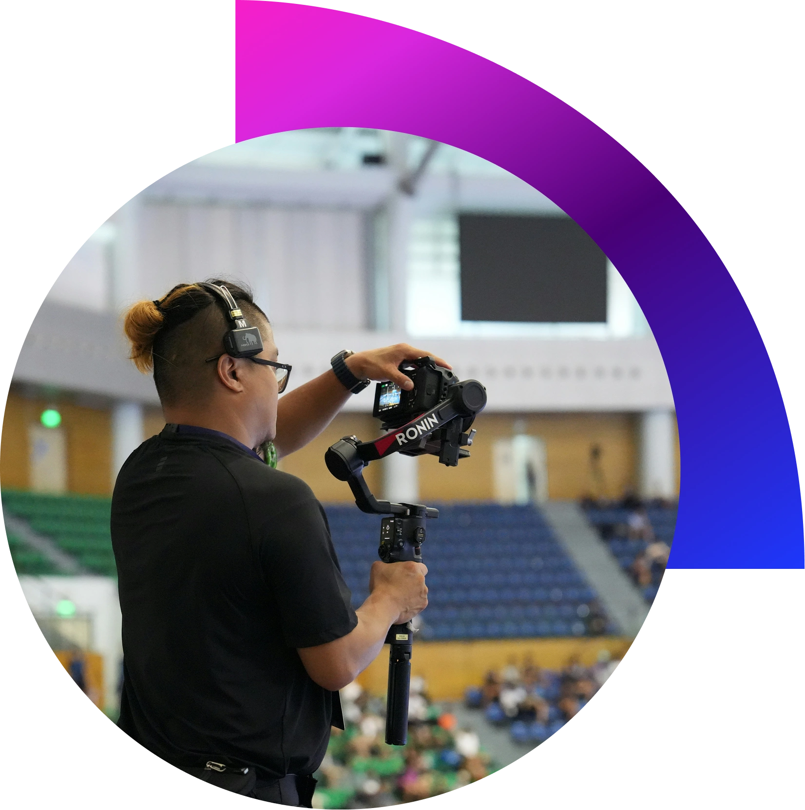 “Videographer filming corporate event stage with professional camera and lighting in Dubai conference hall”