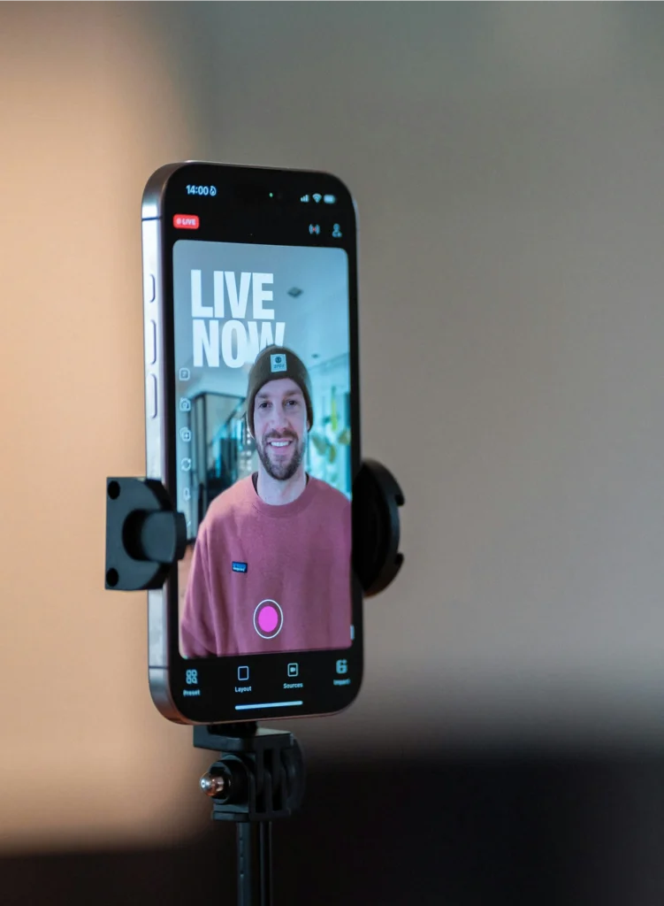 “Live stream videographer managing real-time audio and camera feeds during conference broadcast.”